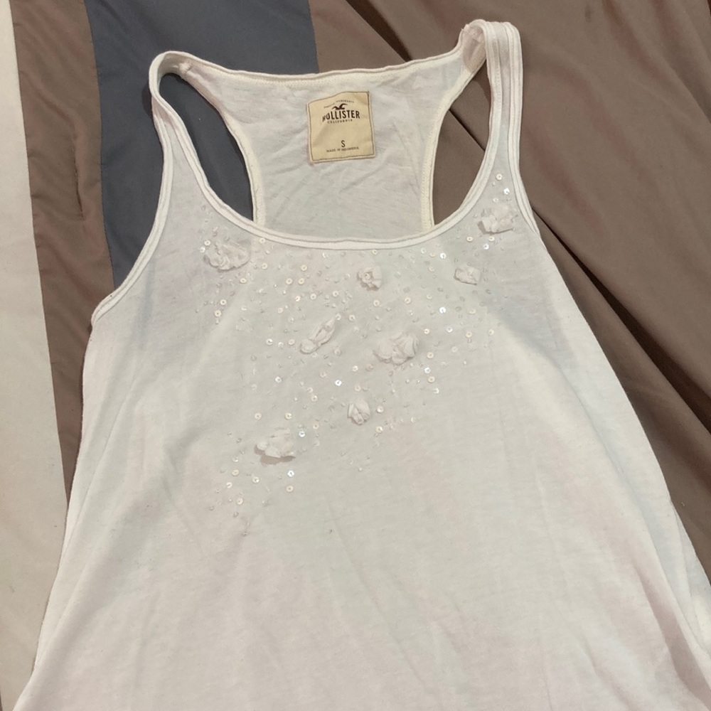 Hollister small, white racerback tank top with sequins and 3D flowers.